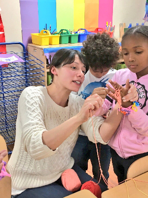 Me teaching children to finger knit.